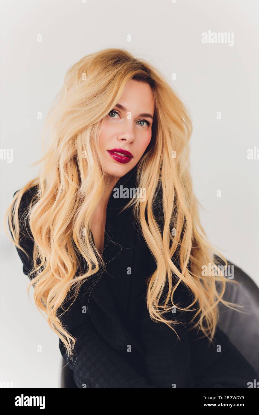 Blonde business woman in a black suit Stock Photo - Alamy