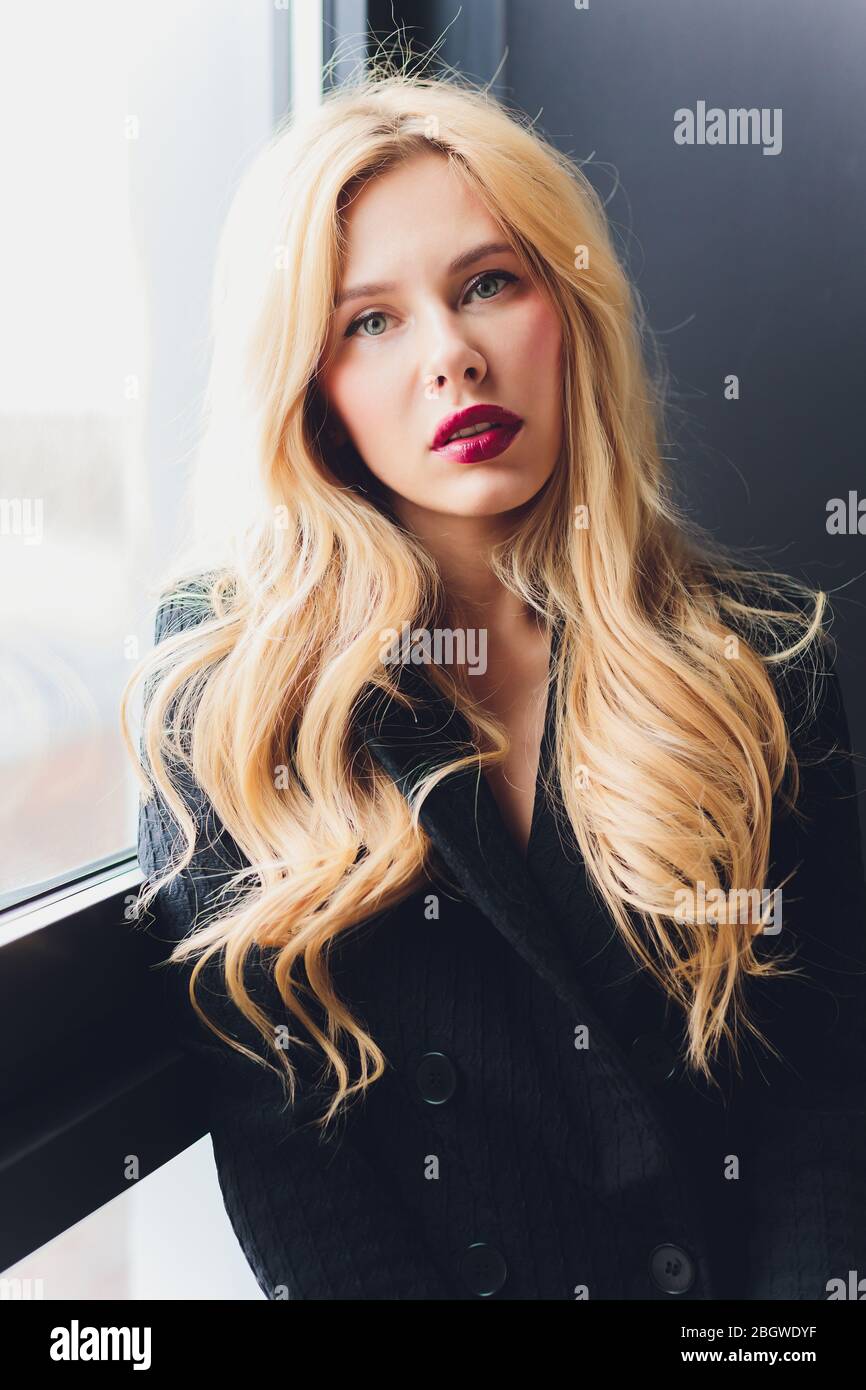 Blonde business woman in a black suit Stock Photo - Alamy