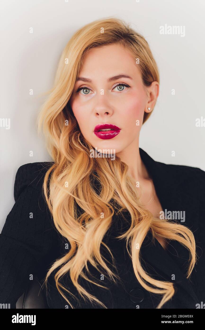 Blonde business woman in a black suit Stock Photo - Alamy