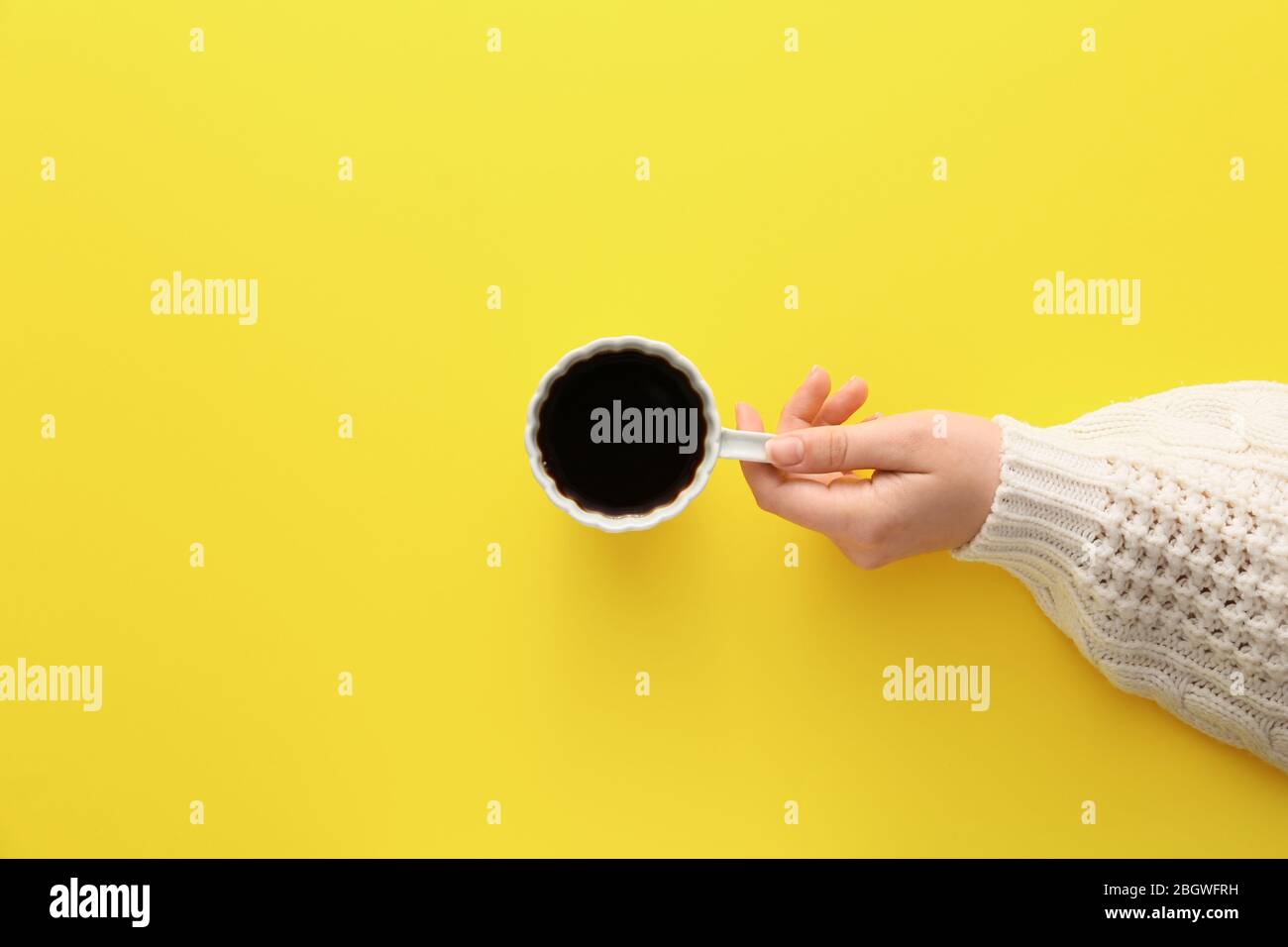 Female hand with cup of hot coffee on color background, top view Stock Photo - Alamy