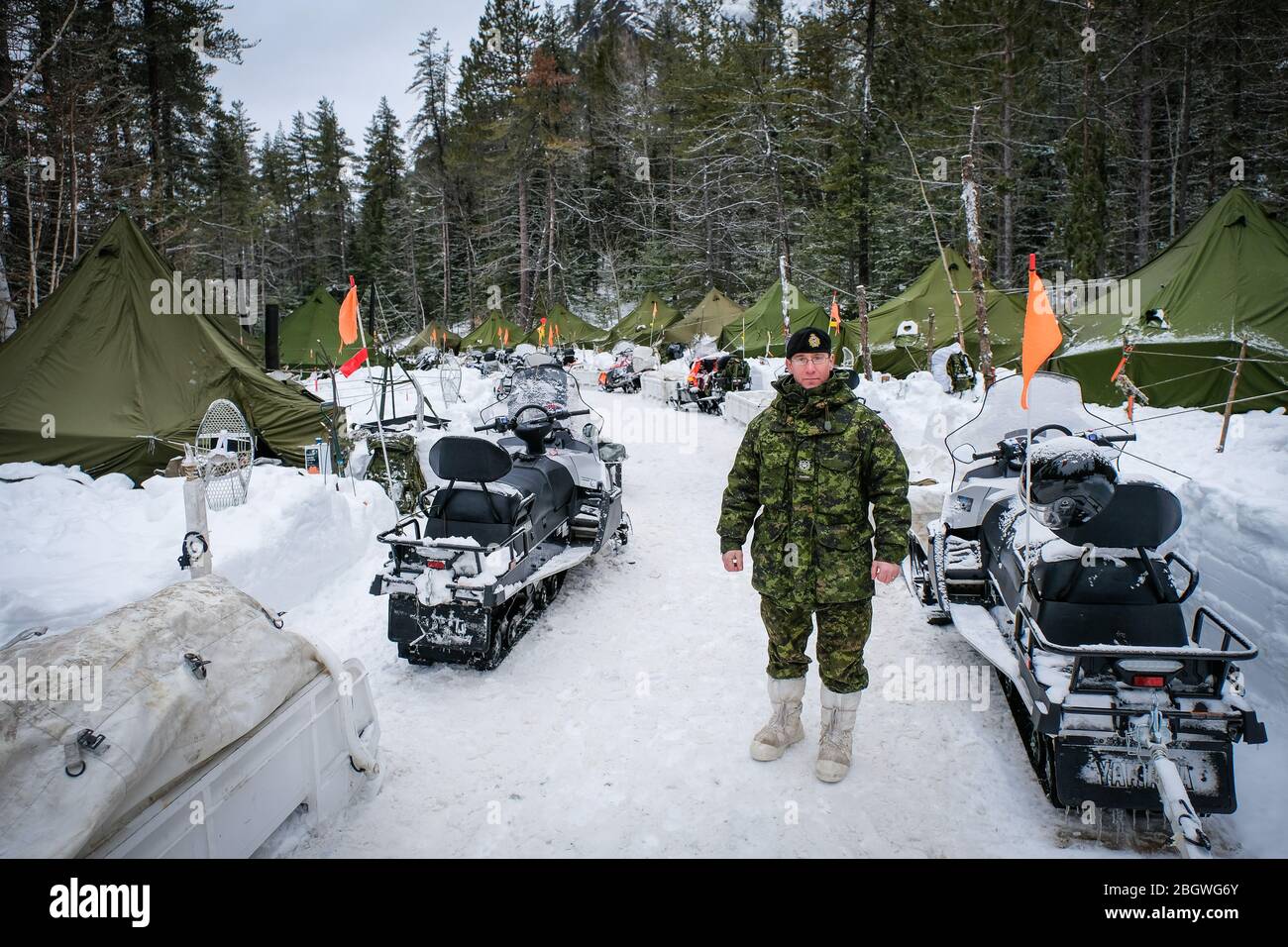 SAGUENAY, CANADA - JANUARY 20: an officer with snowmobiles behind him during a Franco-Canadian military exercise, Quebec, Saguenay, Canada on January Stock Photo