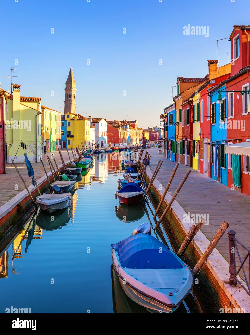 Street with colorful buildings in Burano island, Venice, Italy. Architecture and landmarks of Burano, Venice postcard. Scenic canal and colorful archi Stock Photo
