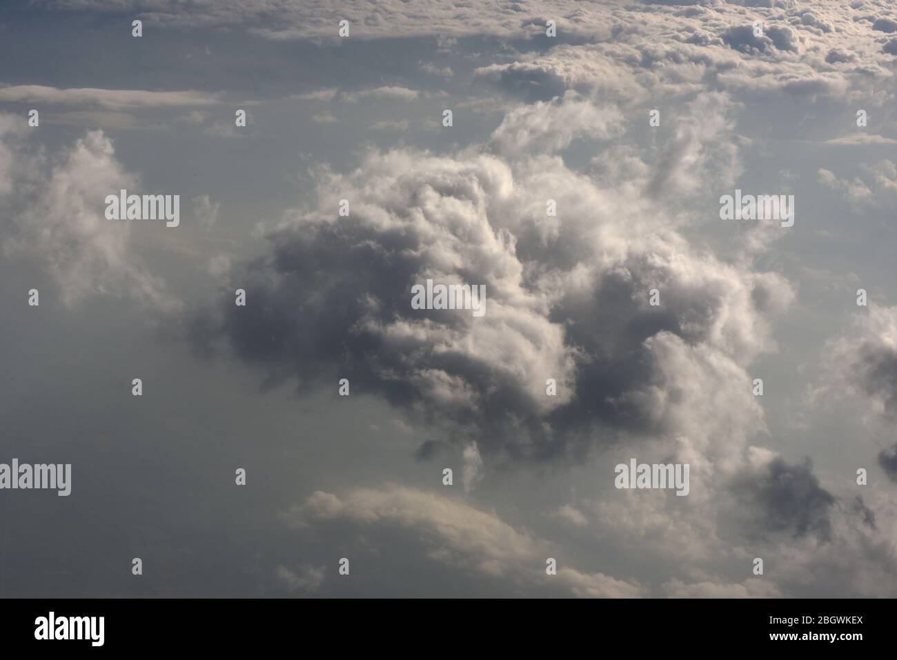 Horizontal image of a view of dark menacing cloud formations from above, looking down from an airplane Stock Photo