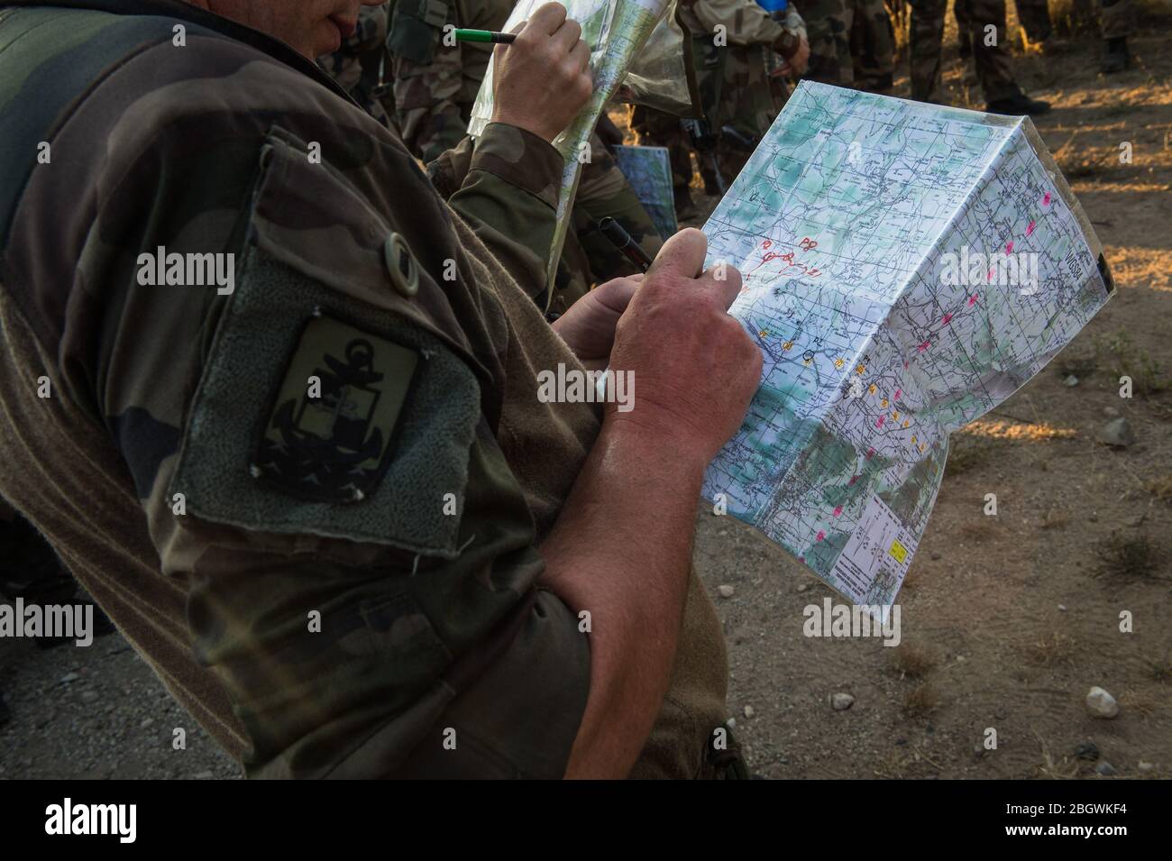 DRAGUIGNAN, FRANCE - JULY 19: two soldiers writing on maps during the preparation in the Canjuers camp of French soldiers leaving for four months of O Stock Photo