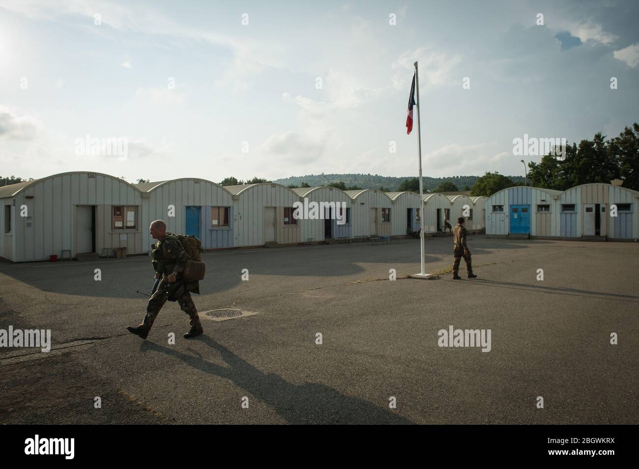 DRAGUIGNAN, FRANCE - JULY 20: soldiers walking in a camp with a french flag during the preparation in the Canjuers camp of French soldiers leaving for Stock Photo