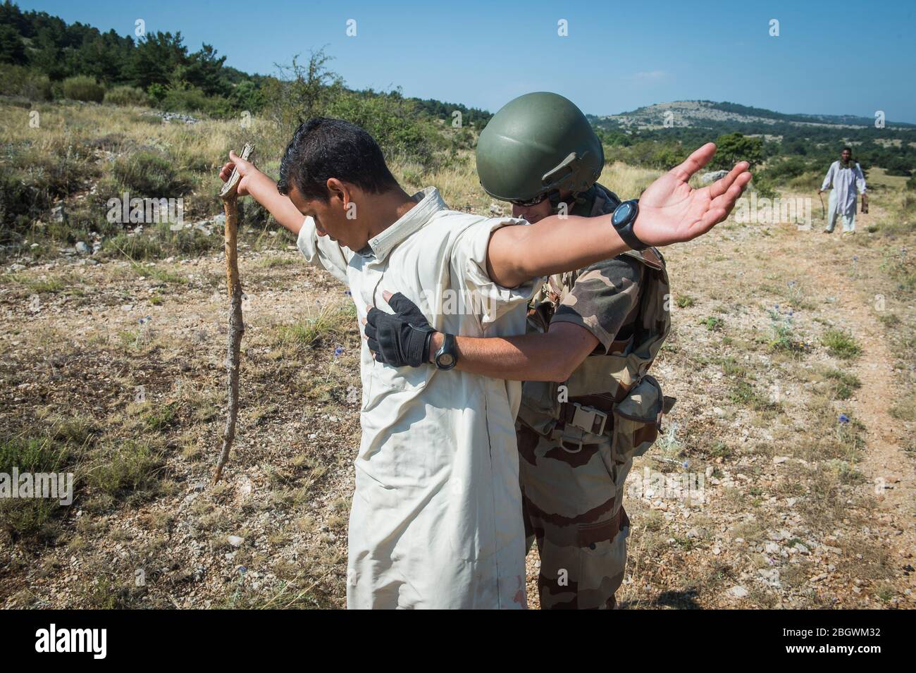 DRAGUIGNAN, FRANCE - JULY 21: a man getting arrested during a simulation of conflict between soldiers and terorists with fake corpses, fake terrorists Stock Photo