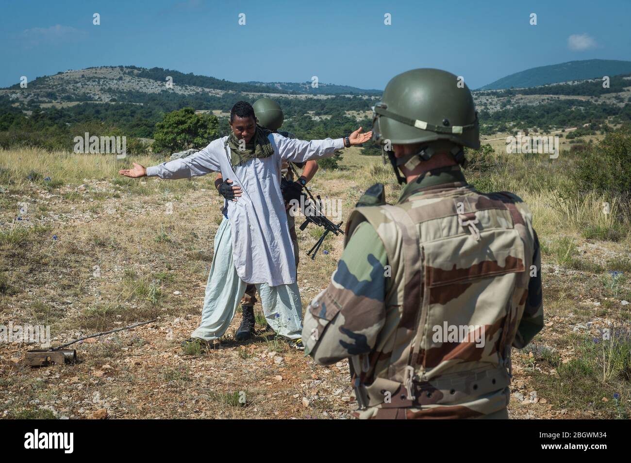 DRAGUIGNAN, FRANCE - JULY 21: a man getting arrested during a simulation of conflict between soldiers and terorists with fake corpses, fake terrorists Stock Photo
