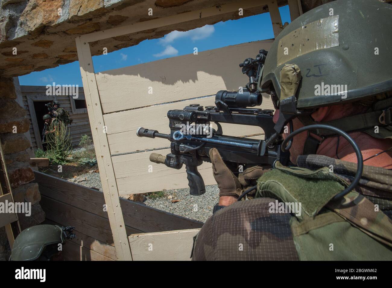 DRAGUIGNAN, FRANCE - JULY 21: a man aiming in the scope of his weapon during a simulation of conflict between soldiers and terorists with fake corpses Stock Photo