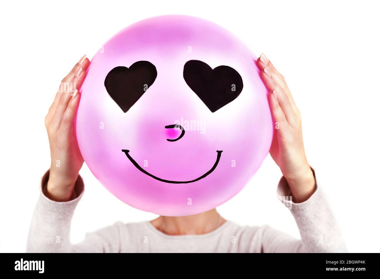 Woman holding balloon in front of her face Stock Photo - Alamy