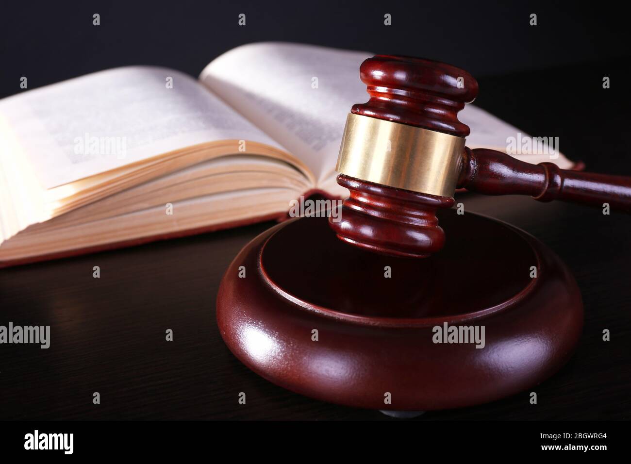 Judge's gavel and open book on table Stock Photo - Alamy