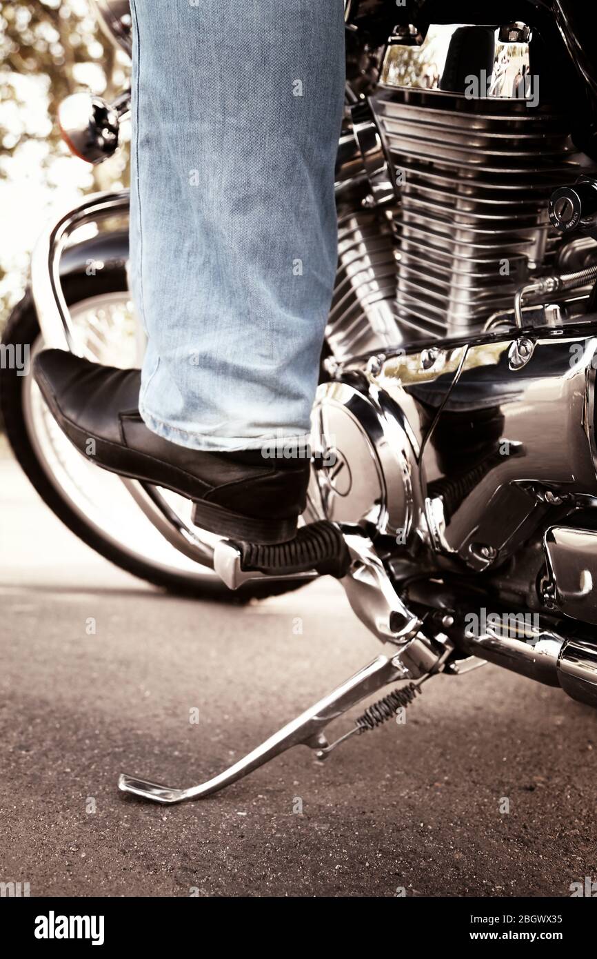 Bikers boot on open road, close-up Stock Photo