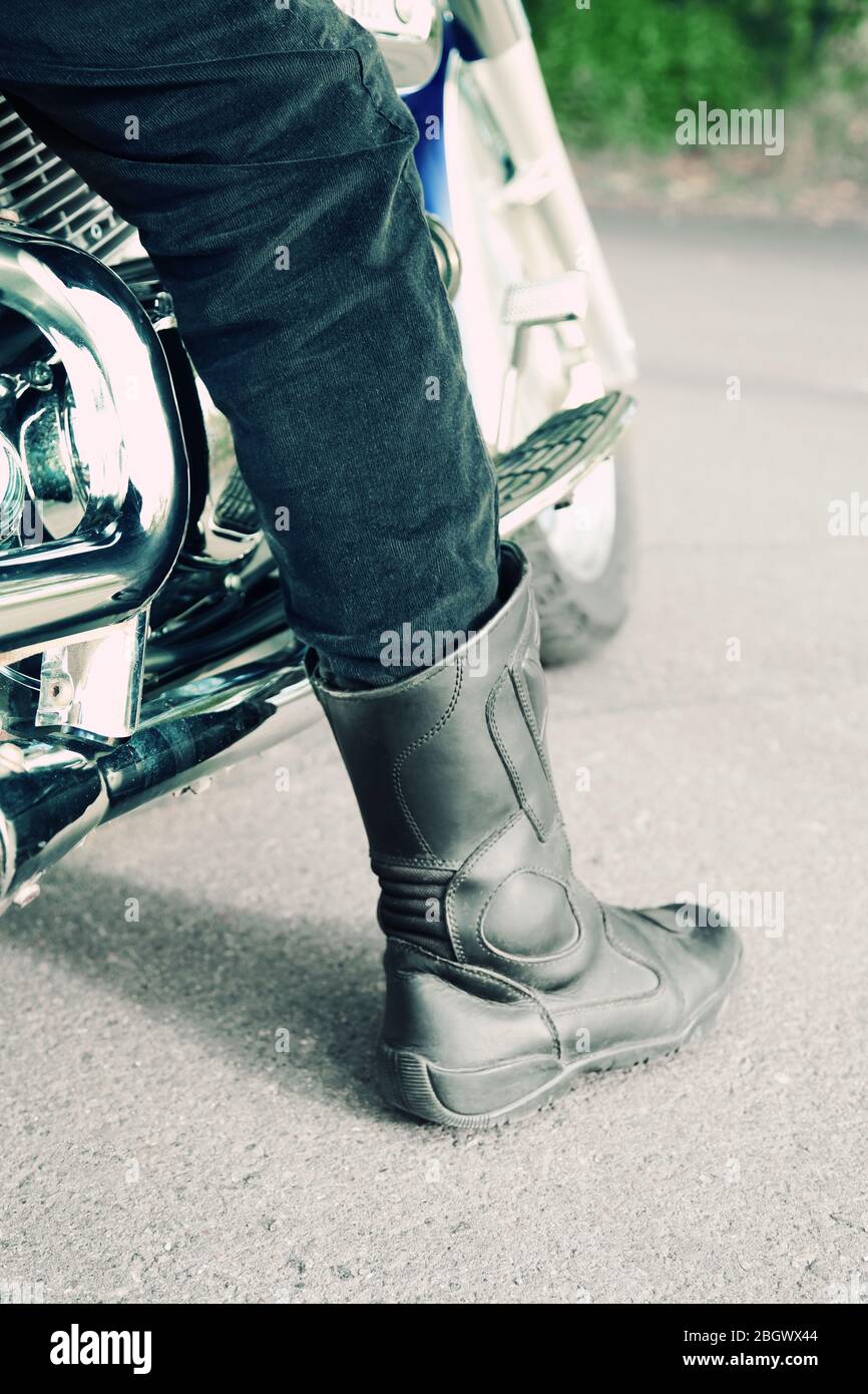 Bikers boot on open road, close-up Stock Photo