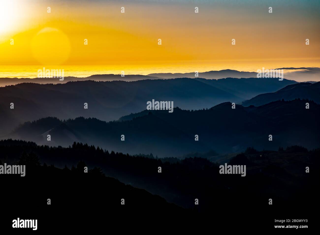 California sunset over the ocean with mountain silhouette Stock Photo