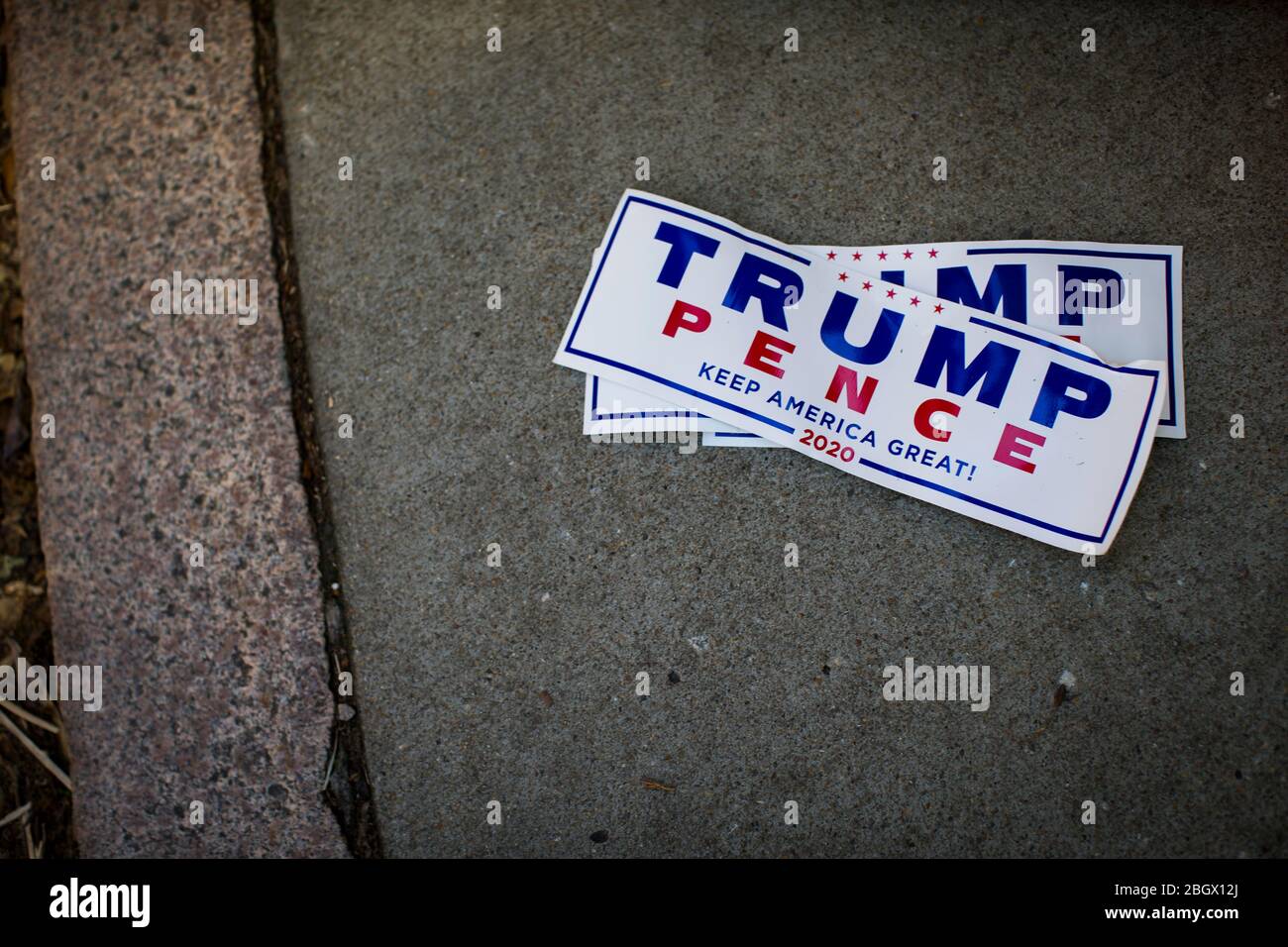 Richmond, Virginia, USA. 22nd Apr, 2020. Trump/Pence campaign stickers were dropped on the sidewalk near Capitol Square during the Reopen Virginia Rally on Wednesday April 22, 2020 in Richmond, VA. President Trump supports a gradual reopening of states that are not COVID-19 hotspots to help reinvigorate the U.S. economy. Credit: John C. Clark/ZUMA Wire/Alamy Live News Stock Photo