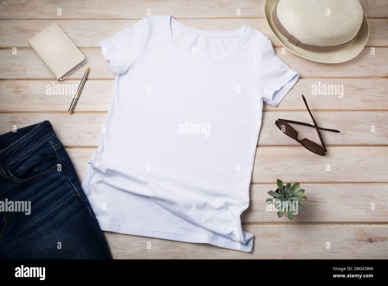 White women’s cotton T-shirt mockup with summer hat, succulent plant and sunglasses. Design t shirt template, tee print presentation mock up Stock Photo