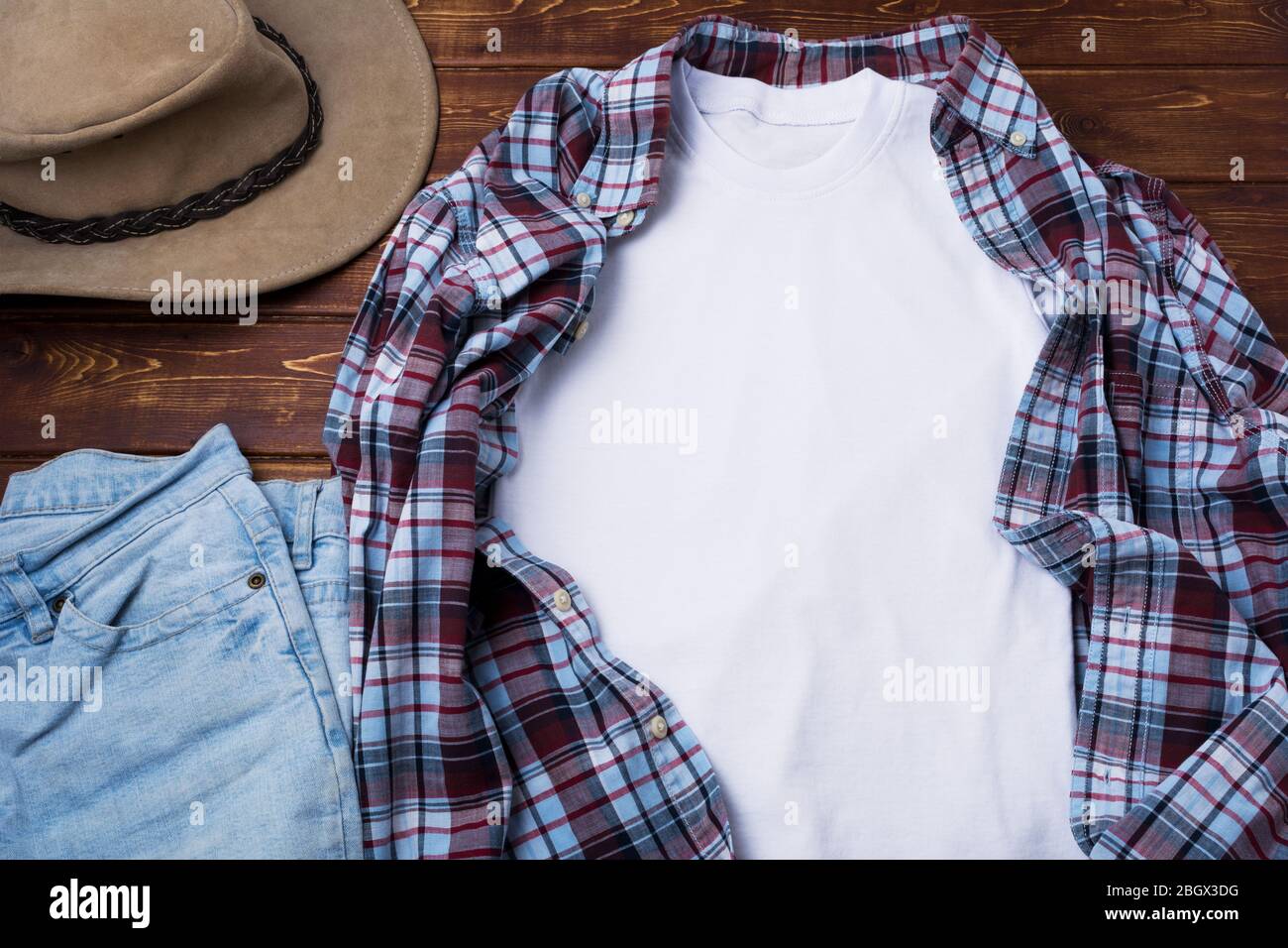 White men’s cotton T-shirt mockup with checkered tartan plaid shirt, blue jeans and cowboy hat. Design t shirt template, tee print presentation mock u Stock Photo