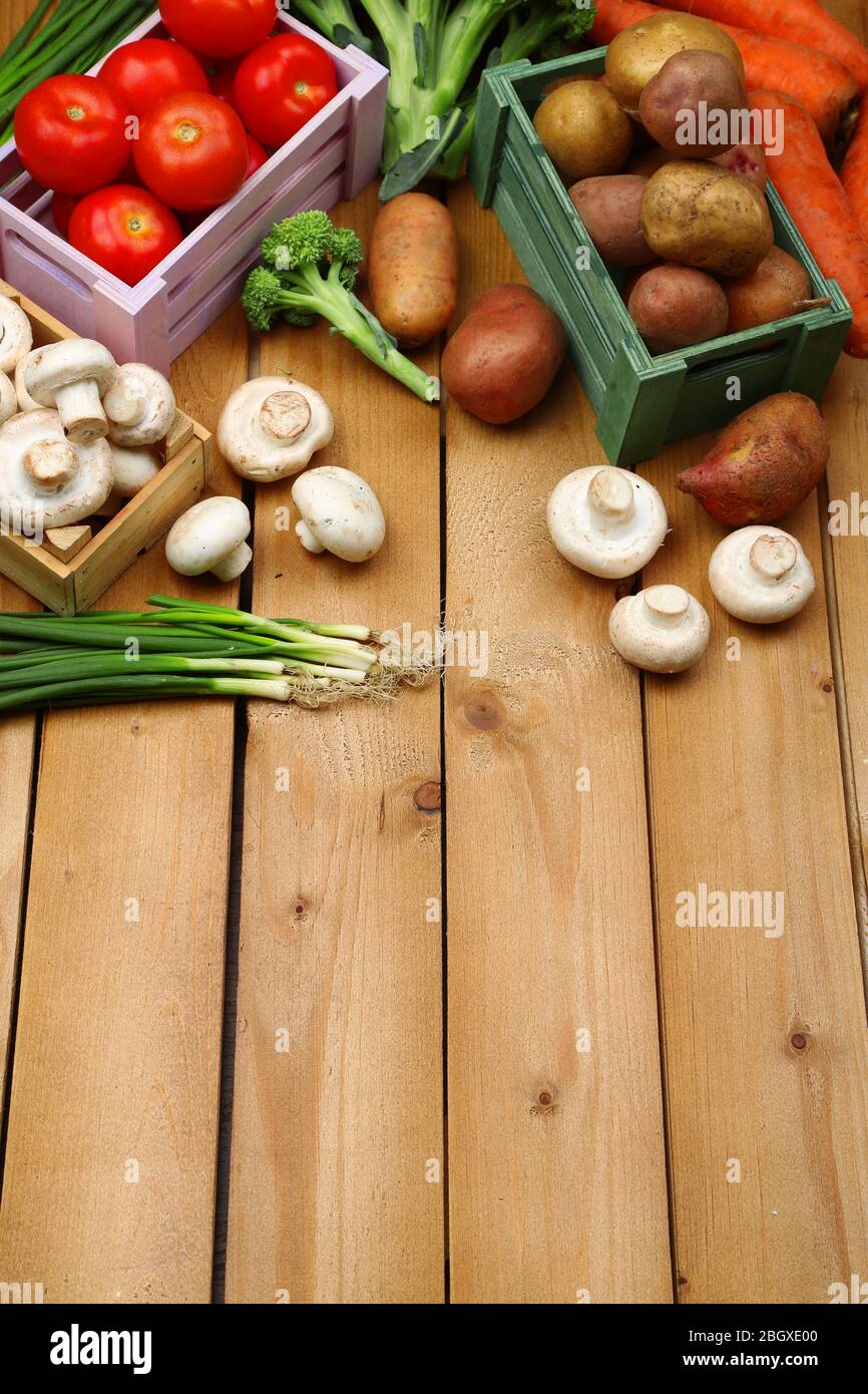 Different vegetables in boxes on wooden background top view Stock Photo Alamy