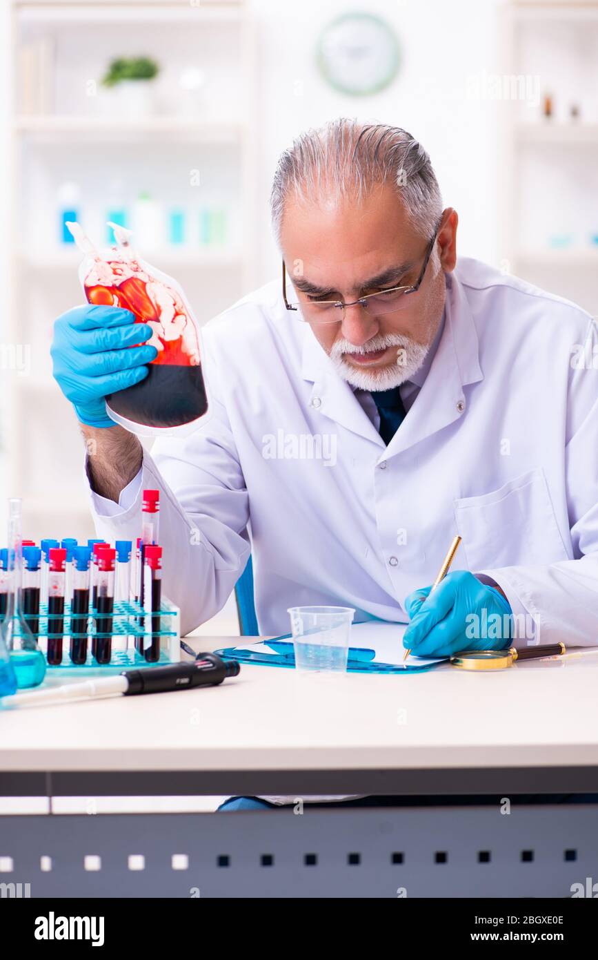 Old chemist working in the lab Stock Photo