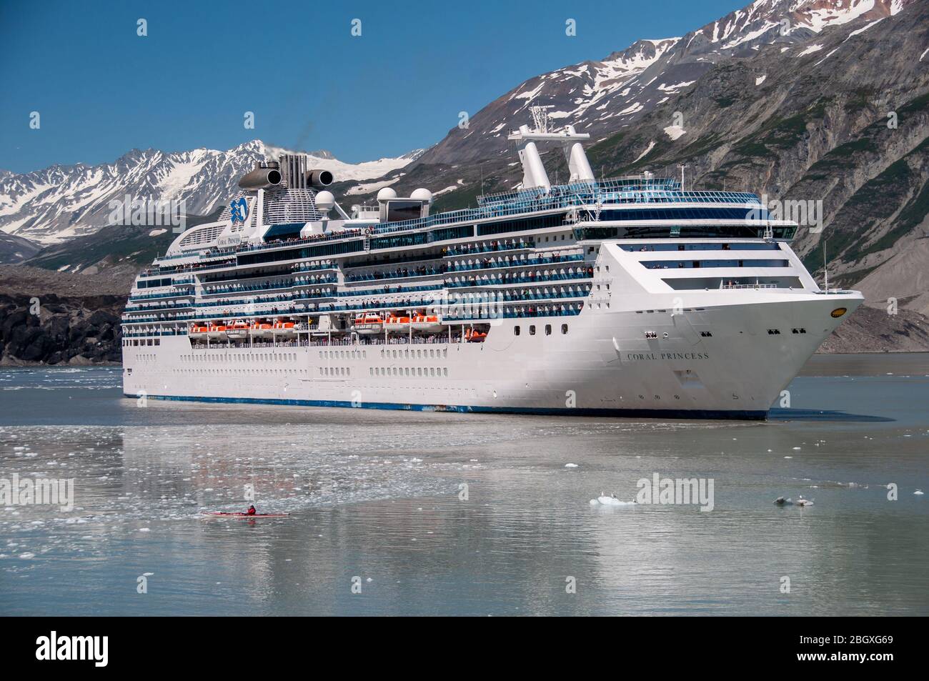 The Coral Princess sits in GlacierBay with a kayaker Stock Photo