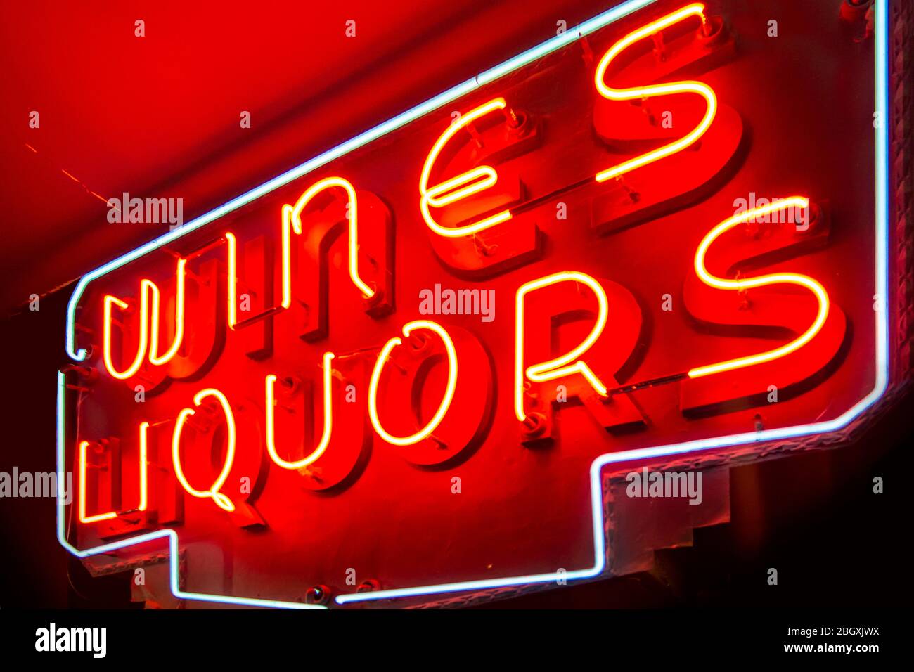 sign with lighted neon lights reading red wines and liquors on an