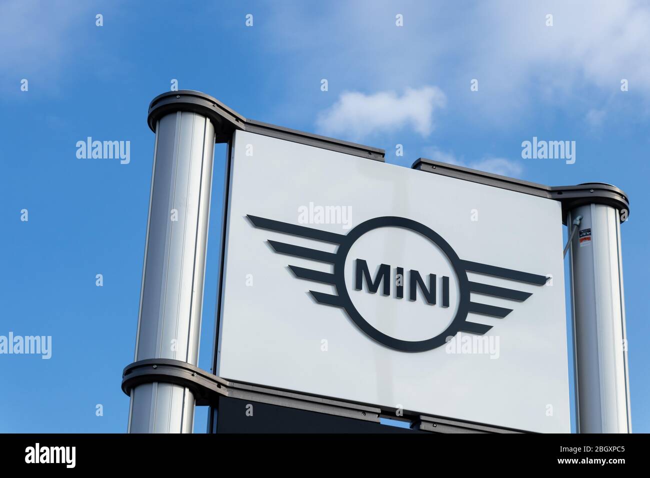 Mini logo on a sign at the front of a dealership, on a sunny day. Stock Photo