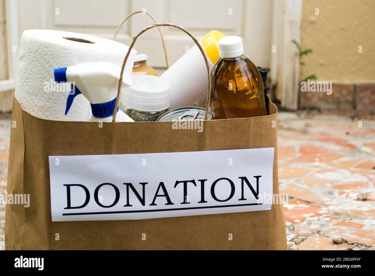 A donation bag filled with food and cleaning supplies is delivered to a home during the Covid-19 / Coronavirus Pandemic Stock Photo