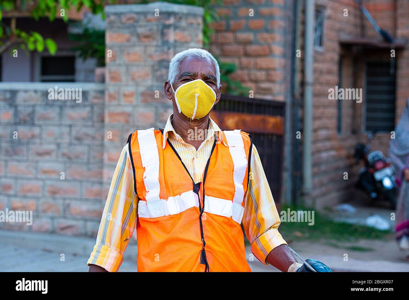 Portrait of Indian cleaning service, old man wearing protective mask, coronavirus, covid-19 outbreak Stock Photo