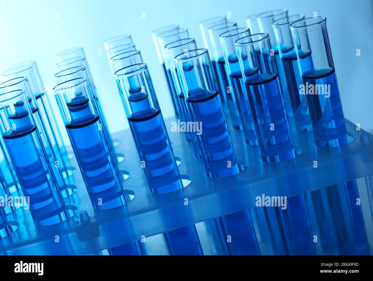 Blue water in a transparent test-tube on light background Stock Photo ...