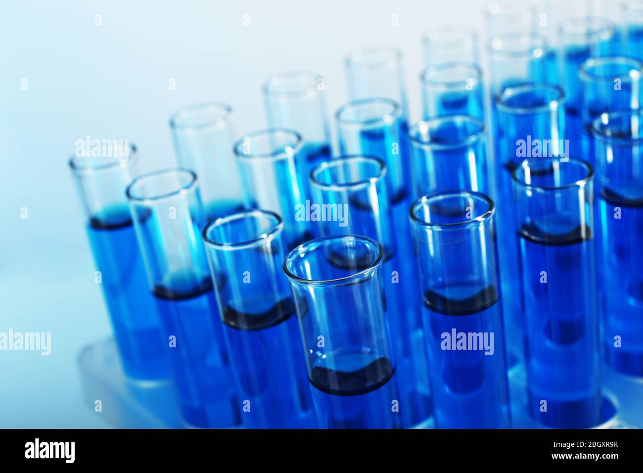 Blue water in a transparent test-tube on light background Stock Photo ...