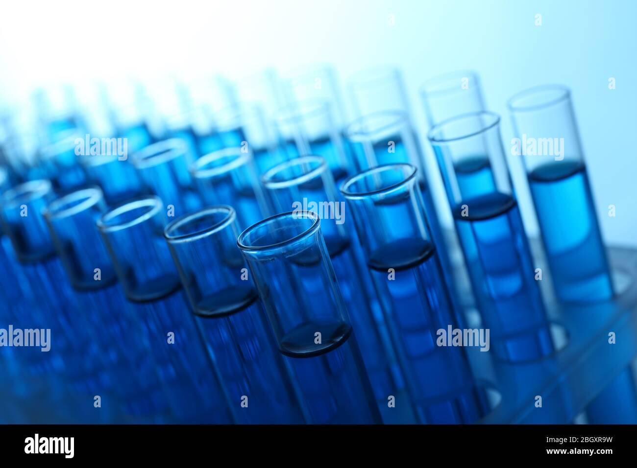 Blue water in a transparent test-tube on light background Stock Photo ...