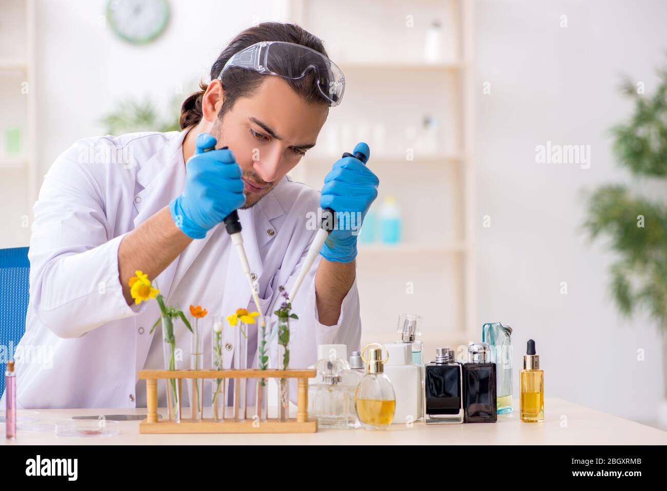 Young chemist in perfume synthesis concept Stock Photo Alamy