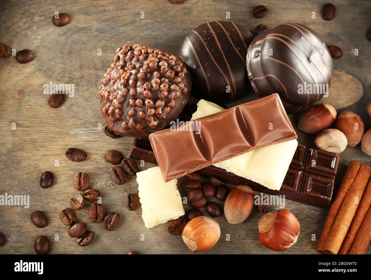 Chocolate cookies with coffee beans, nuts and cinnamon on wooden background Stock Photo