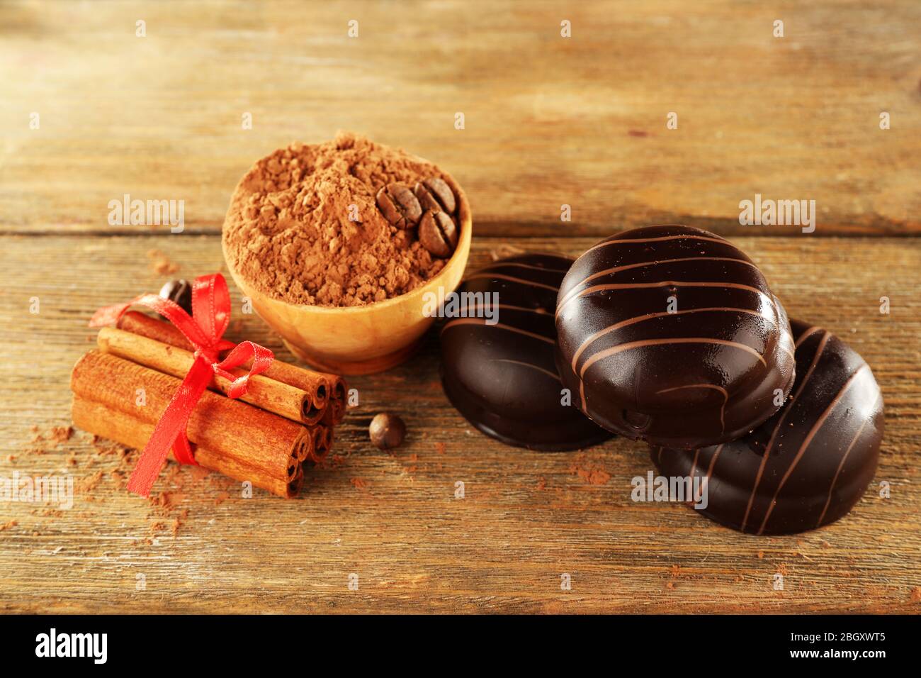 Chocolate cookies with bowl of cocoa and cinnamon on rustic background Stock Photo