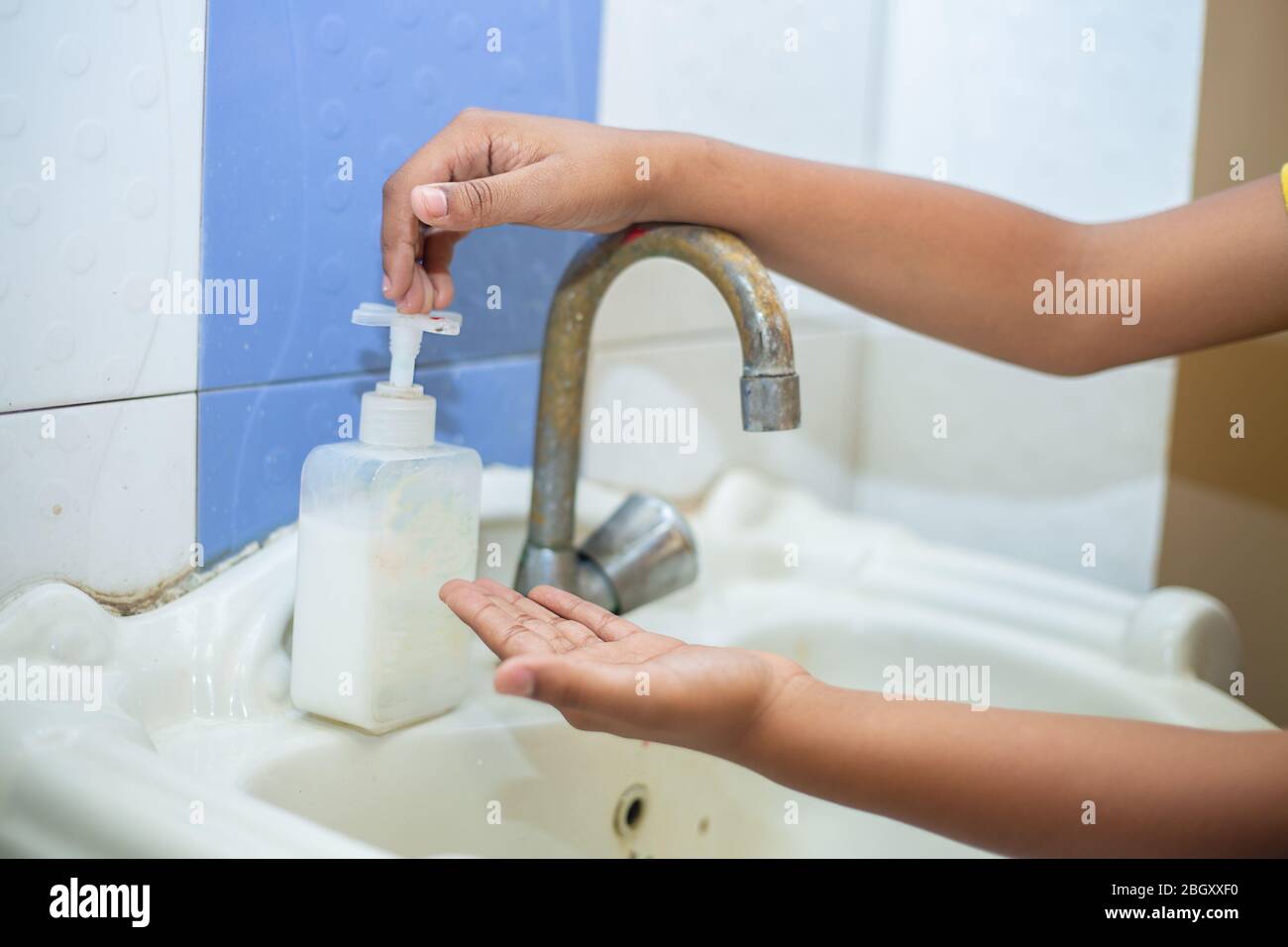 Kid washing hands with alcohol gel or antibacterial soap sanitizer, Hygiene concept. prevent the spread of germs and bacteria and avoid infections cor Stock Photo