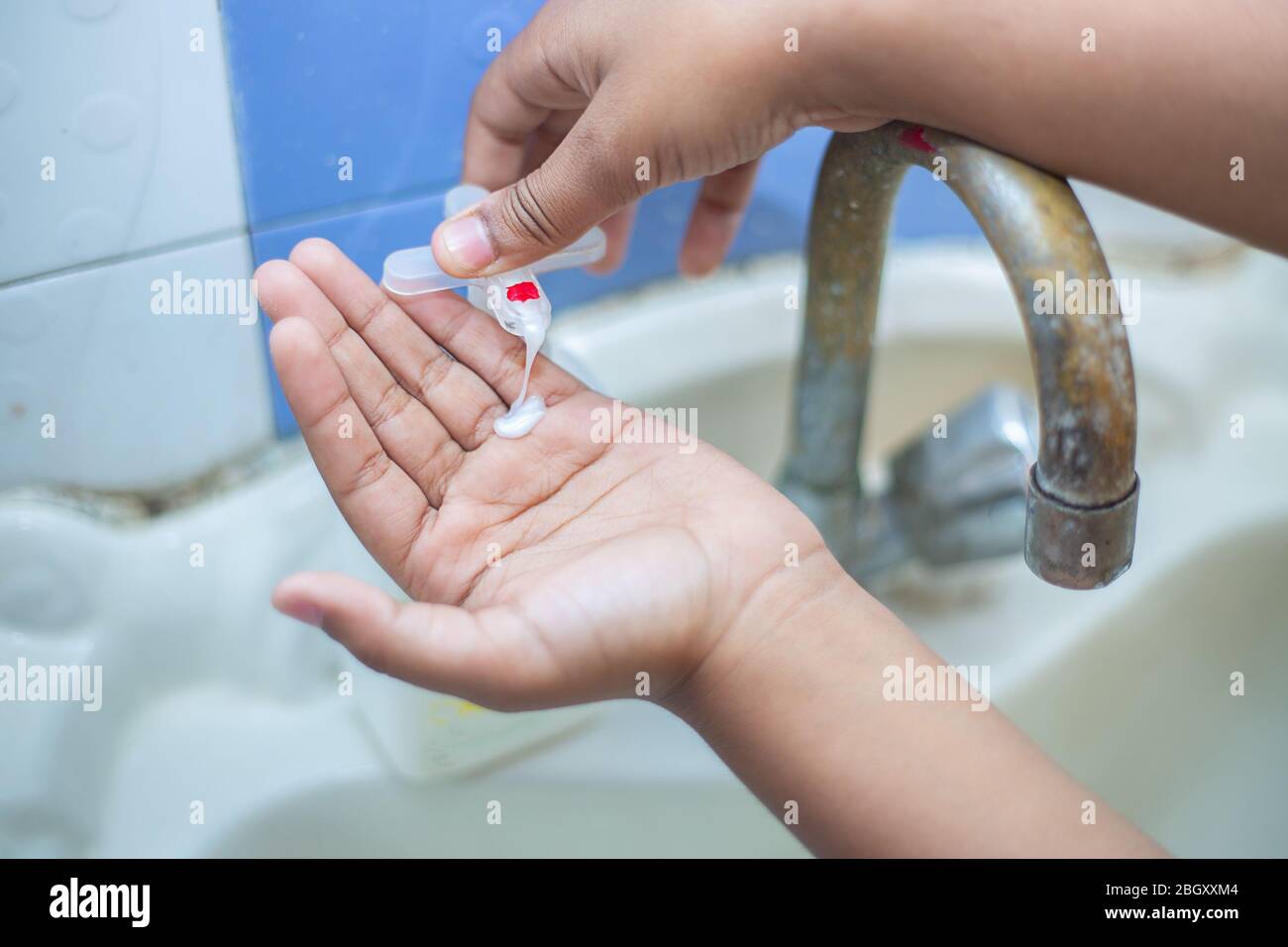 Kid washing hands with alcohol gel or antibacterial soap sanitizer, Hygiene concept. prevent the spread of germs and bacteria and avoid infections cor Stock Photo