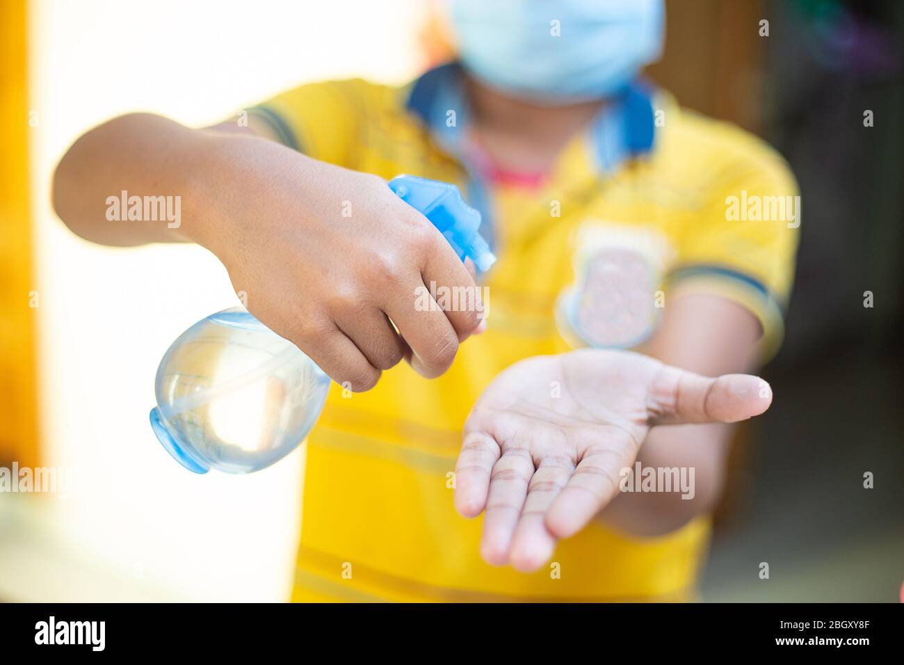 Asian people using alcohol antiseptic gel and wearing prevention mask,prevent against infection of Covid-19 outbreak,woman washing hands with hand san Stock Photo
