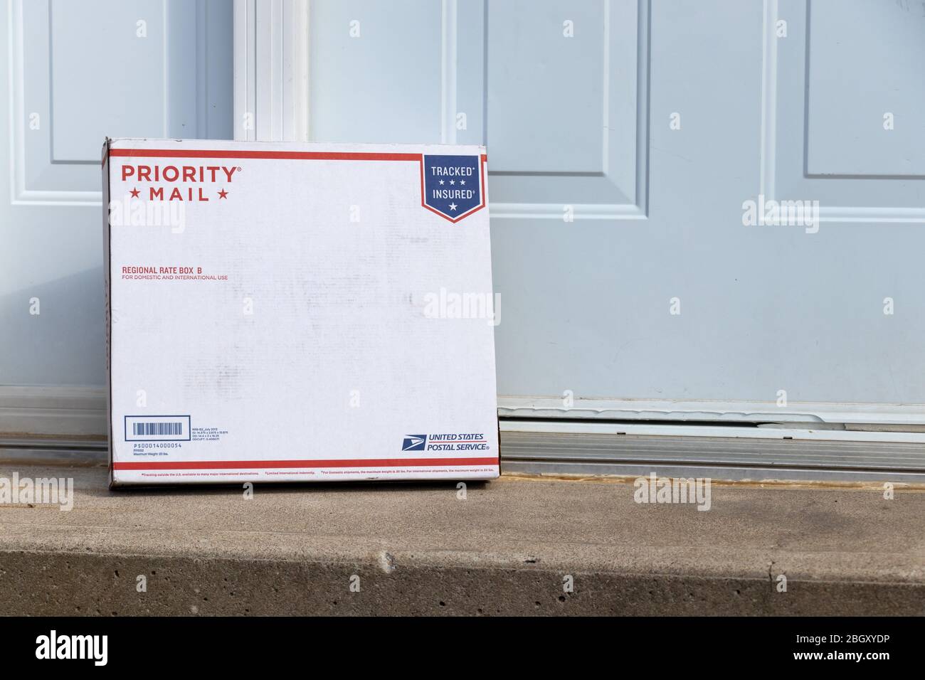 United States Parcel Service (USPS) package delivered to a front door. Stock Photo
