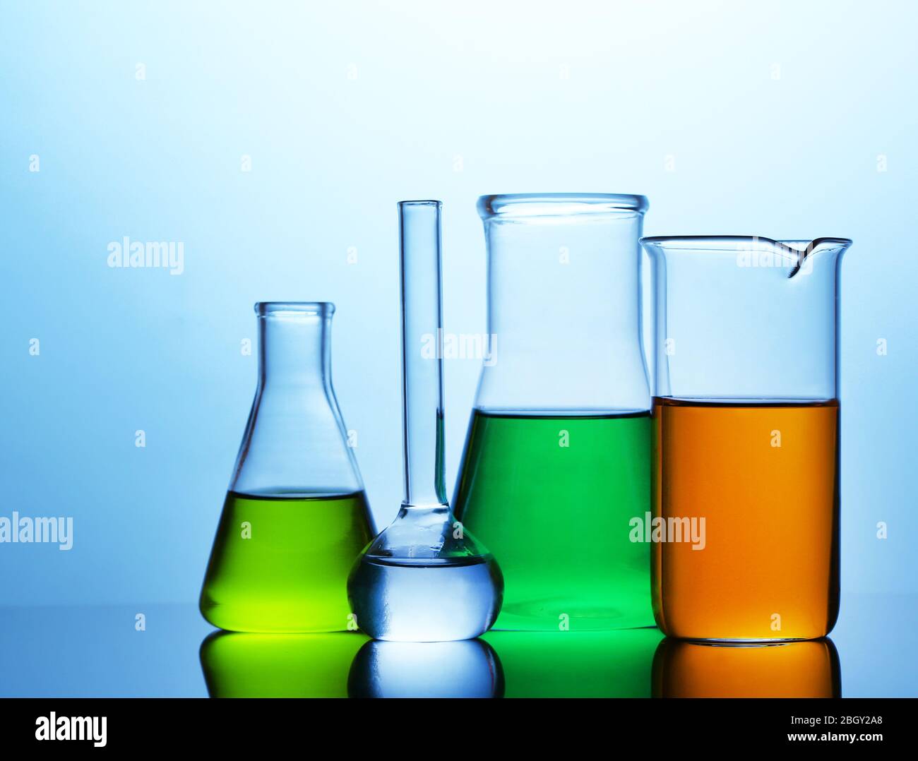 Test tubes with liquid on bright blue background Stock Photo - Alamy