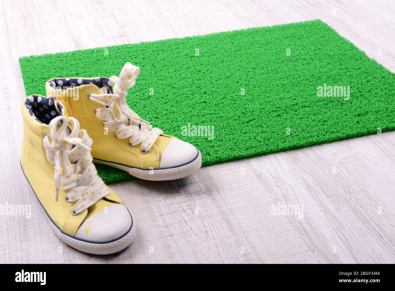 Green carpet on floor and converse close-up Stock Photo - Alamy