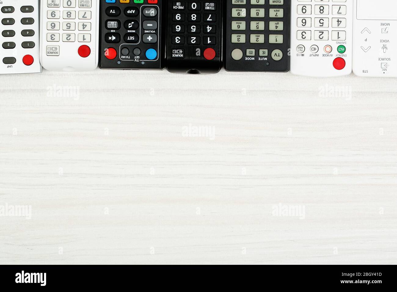 Many remote control devices on table Stock Photo