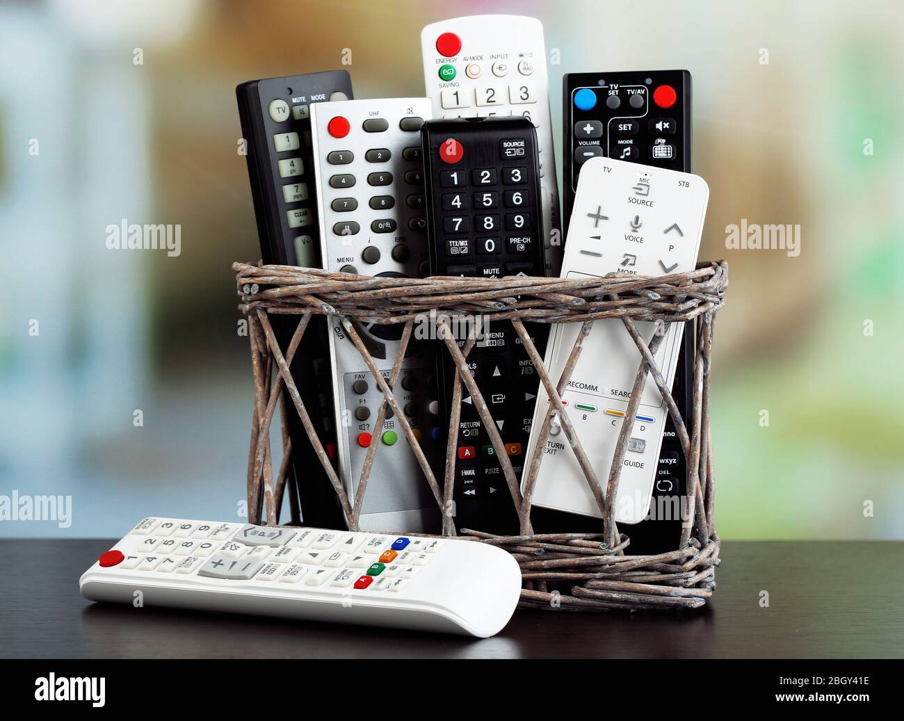 Many remote control devices in basket on bright background Stock Photo Alamy