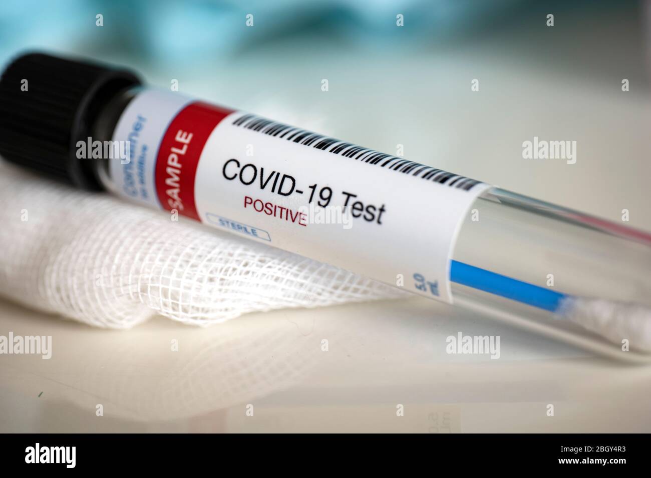 Testing for presence of coronavirus. Tube containing a swab sample that has tested positive for COVID-19. Stock Photo