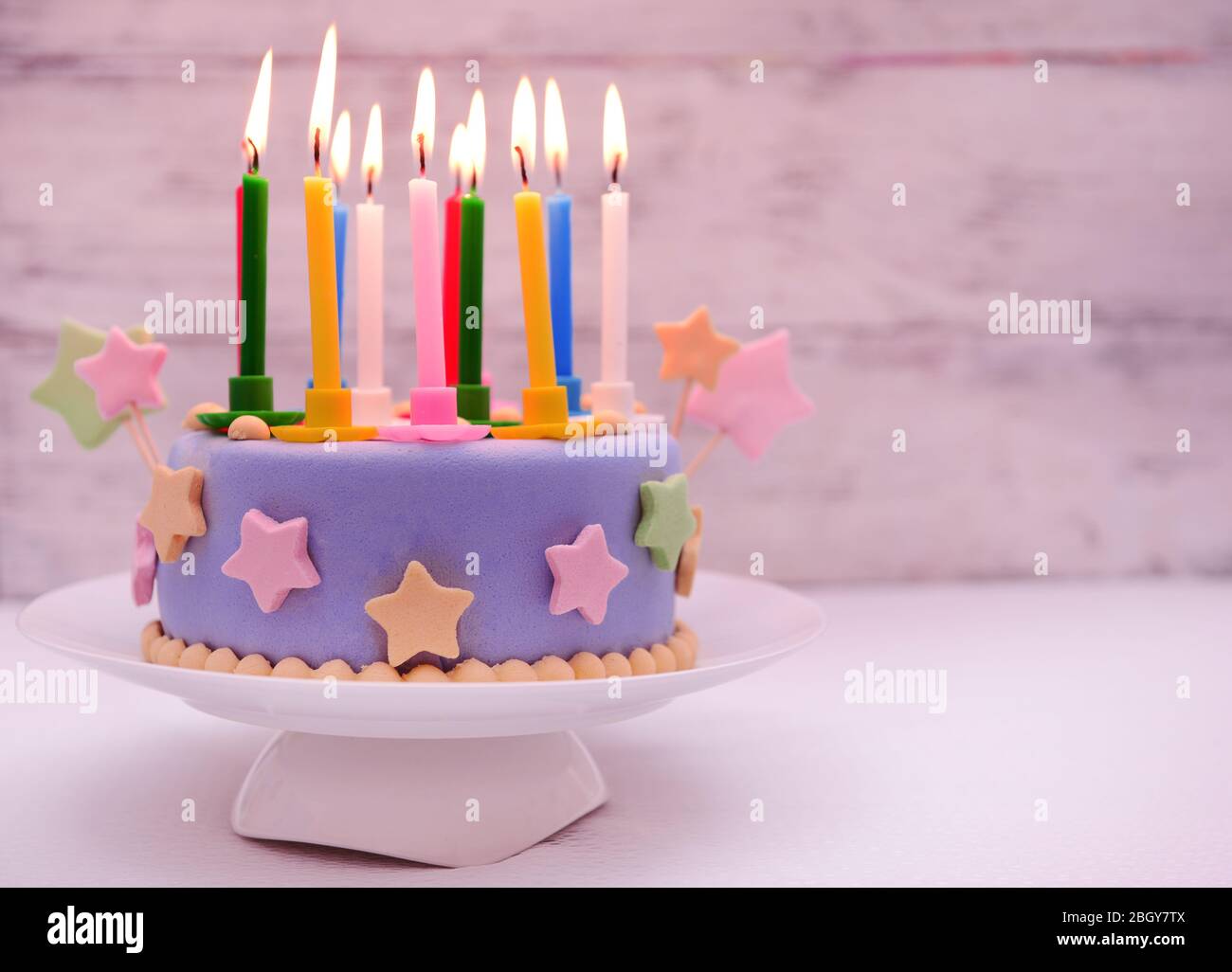 Delicious birthday cake on table on light background Stock Photo - Alamy
