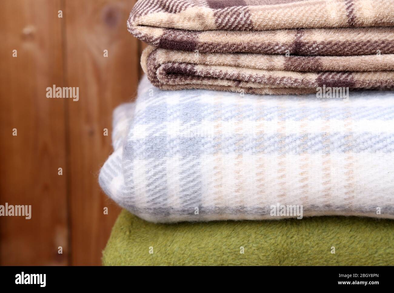 Warm plaids on rustic wooden background Stock Photo