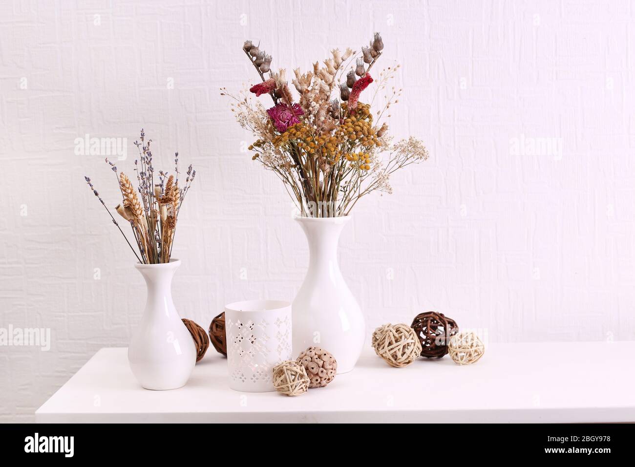 Composition of dried flowers on white wall background Stock Photo - Alamy