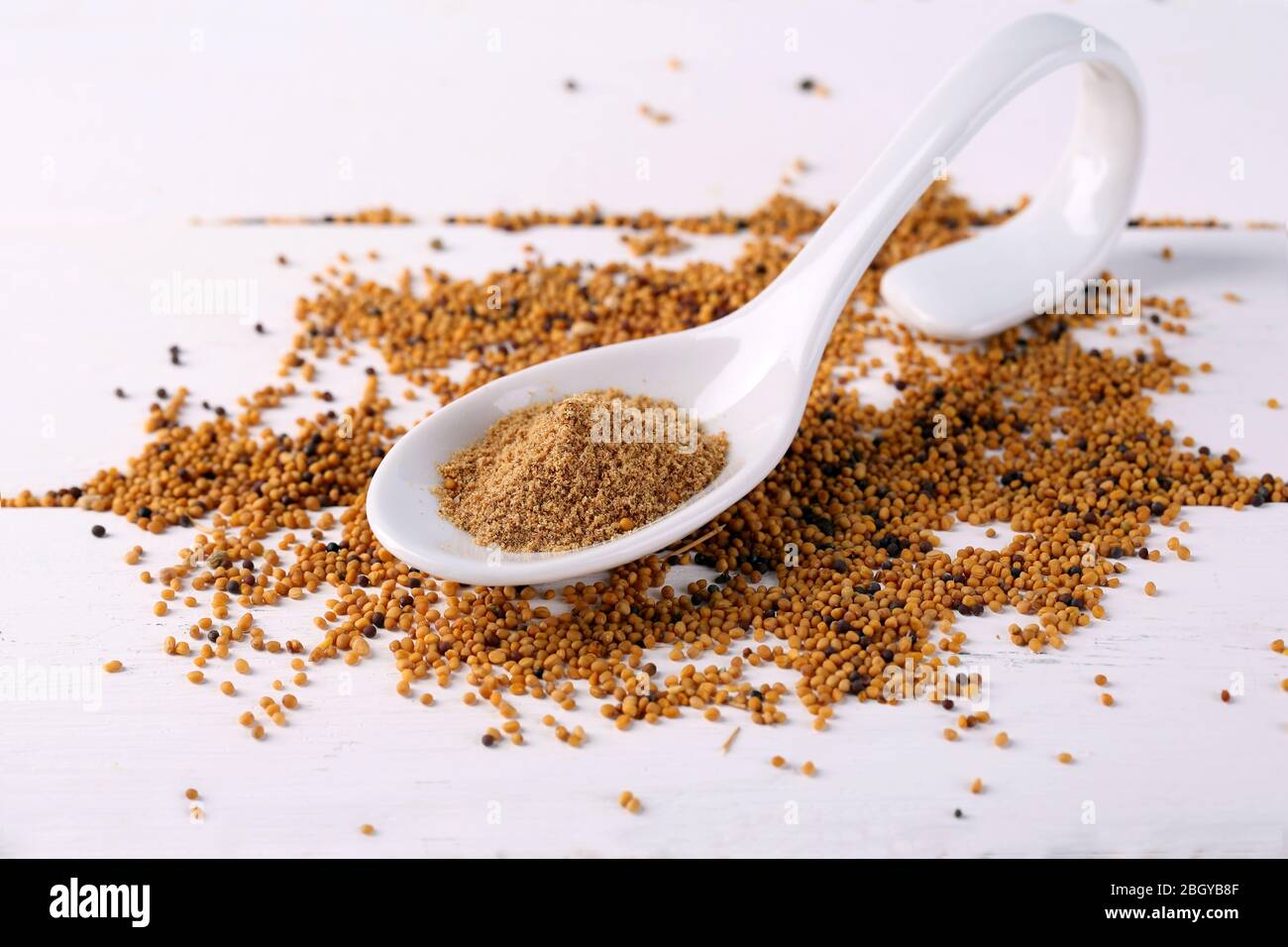 Mustard Powder In Spoon On Mustard Seeds On Wooden Background Stock Photo Alamy