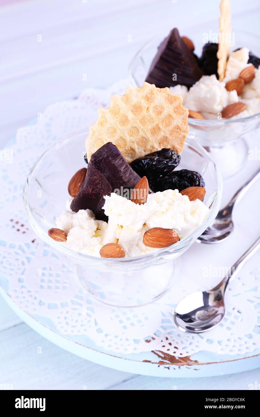 Sweets Using Prunes Dessert with prunes in glass bowls on color wooden table background ...