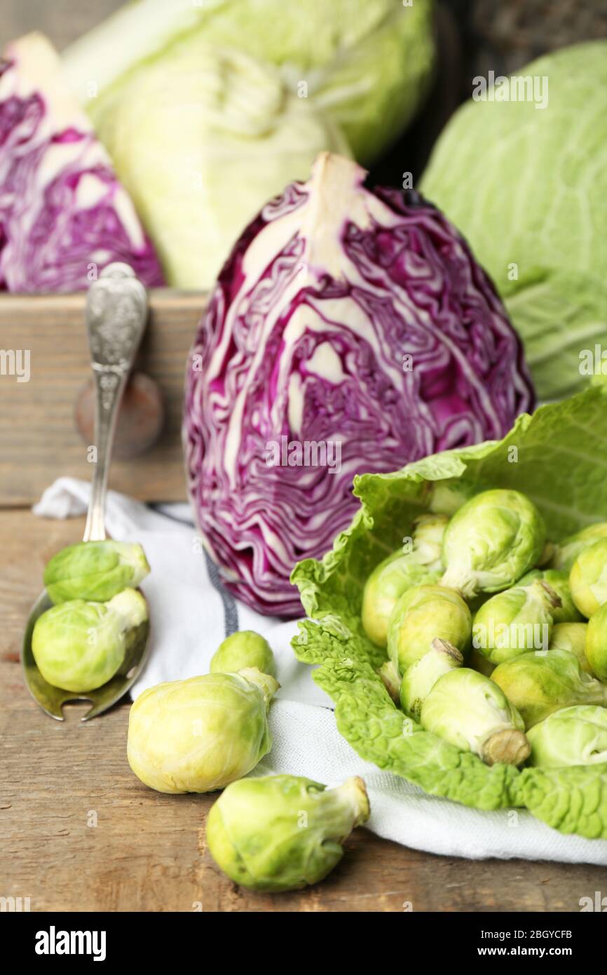 Still life with assortment cabbages on wooden background Stock Photo