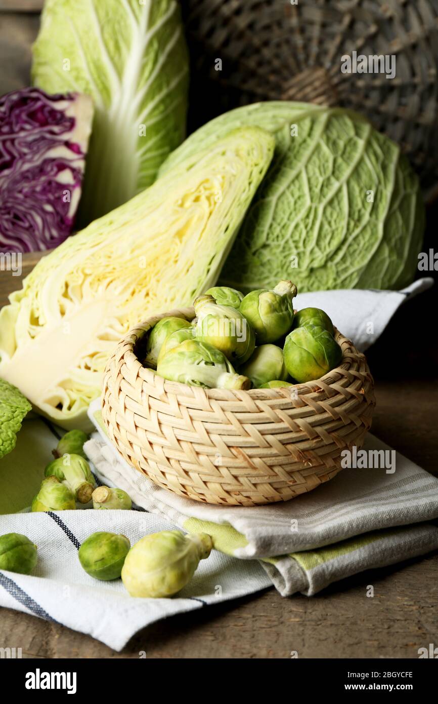 Still life with assortment cabbages on wooden background Stock Photo