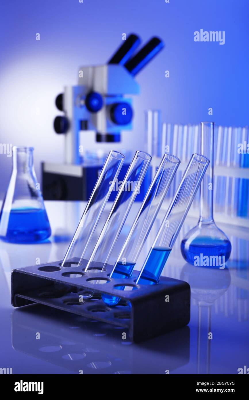 Laboratory glassware with blue liquid on bright background Stock Photo ...